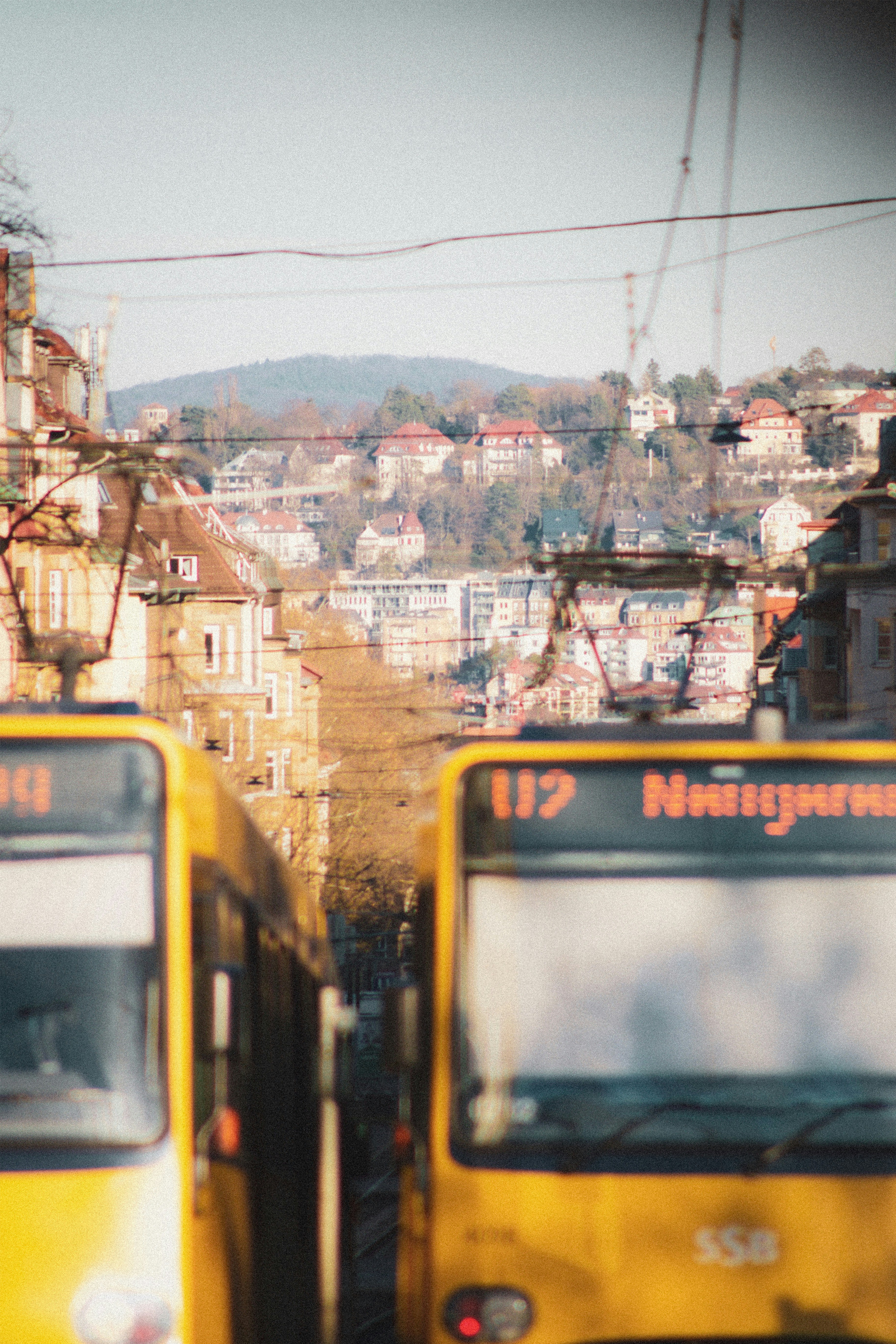 yellow and white train on rail tracks during daytime